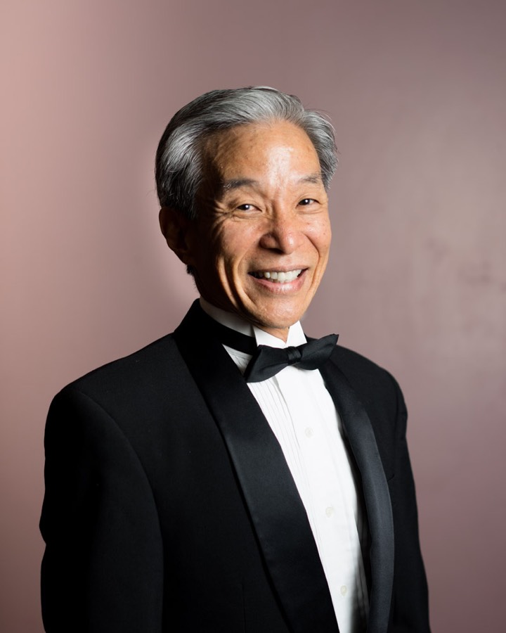 A smiling HBDA instructor in a black tuxedo and bow tie