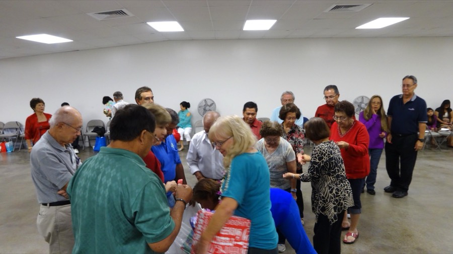 A crowded HBDA social with members mingling around tables